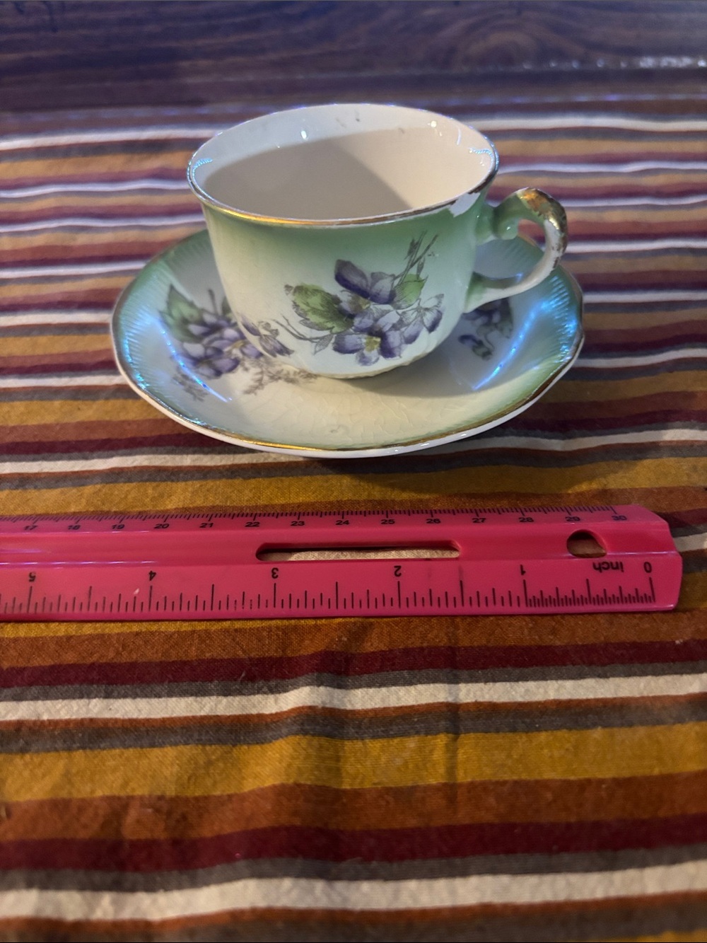 Green Porcelain Teacup and Saucer with Purple Floral Accents